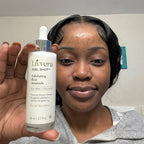 Person holding a bottle of Livvera peel shot exfoliating rice ampoule.