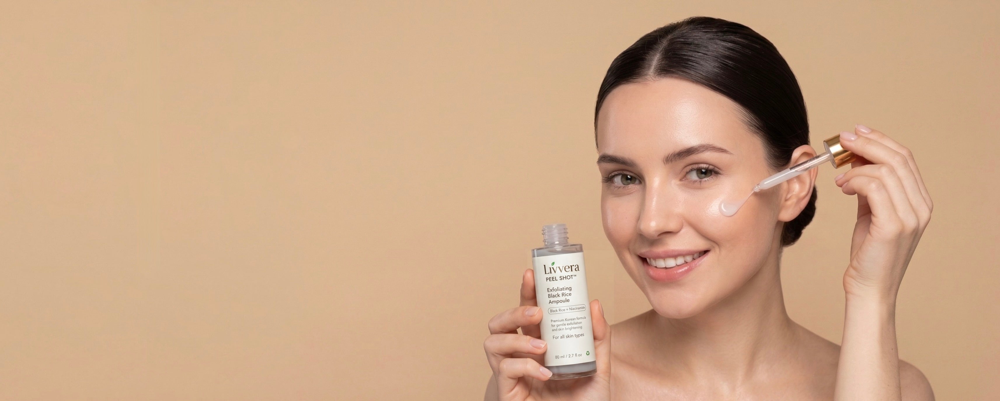 Woman applying skincare product with a beige background