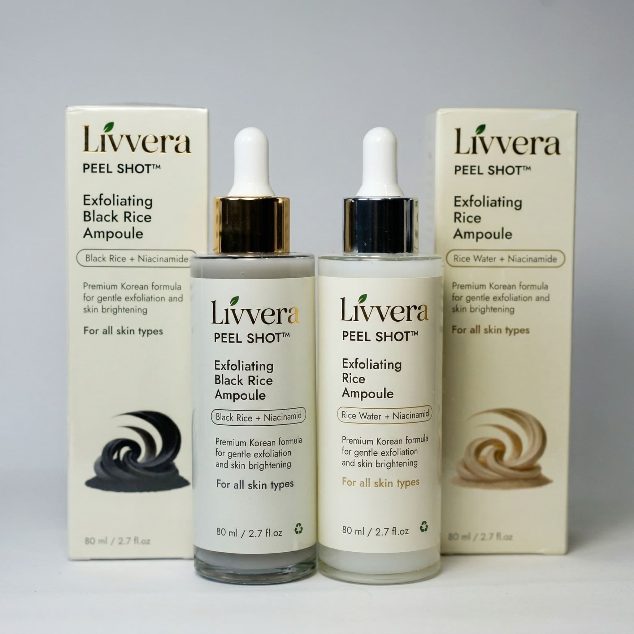 Livvera Exfoliating Black Rice Ampoule and Rice Ampoule bottles with boxes on a gray background